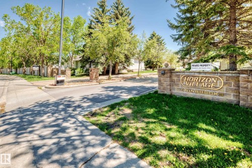 Stone entry monument with embossed lettering - 50 303 Twin Brooks Drive Nw, Edmonton, AB 