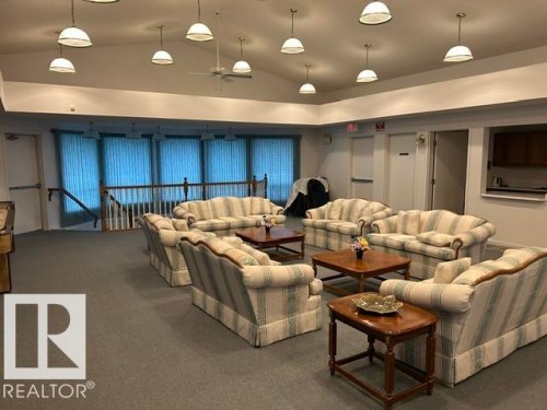 Spacious common area featuring vaulted ceilings, recessed lighting, and ample natural light from multiple windows - 50 303 Twin Brooks Drive Nw, Edmonton, AB 