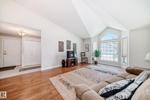 Vaulted ceiling living space with wood-finish flooring - 50 303 Twin Brooks Drive Nw, Edmonton, AB 