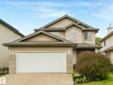 Two-story residence featuring light-toned siding, a two-car garage, brick accents, and a prominent arched window on the second level - 1116 Lincoln Crescent, Edmonton, AB  - Outdoor 
