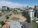 Expansive vacant lot featuring a cleared surface, surrounding commercial and residential buildings, and proximity to a multi-lane roadway - 7915 114 Street Nw, Edmonton, AB 