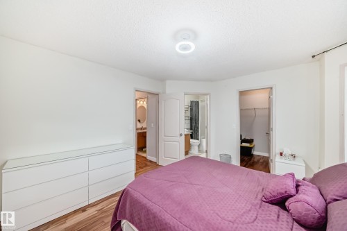 Spacious room featuring wood-finish flooring, white walls, and a recessed ceiling light - 8 Campbell Court, Leduc, AB 