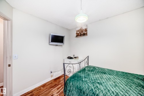 Wood-finish flooring with a white baseboard - 8 Campbell Court, Leduc, AB 