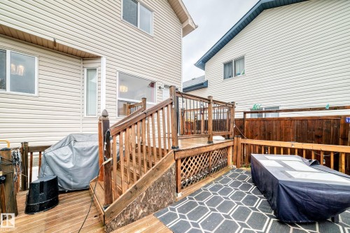 Multi-level wood deck featuring a lattice skirt, wood railings, and a wood privacy fence - 8 Campbell Court, Leduc, AB 