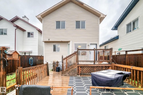 Multi-level wood-finish decking with railings and privacy fencing - 8 Campbell Court, Leduc, AB 
