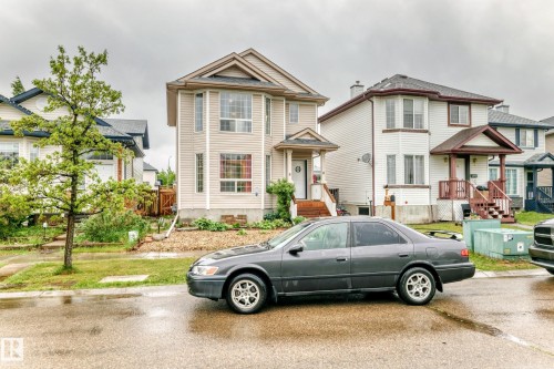 Two-story residence featuring light-colored siding and a covered front porch - 8 Campbell Court, Leduc, AB 