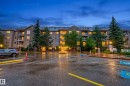 Multi-story building featuring multiple private balconies, a paved parking area, and mature landscaping - 413 8912 156 Street Nw, Edmonton, AB 