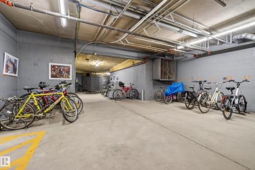 Dedicated bicycle storage area featuring concrete flooring and exposed ceiling utilities - 413 8912 156 Street Nw, Edmonton, AB 