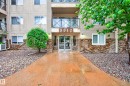 Building exterior with stone veneer accents and a prominent central entry - 413 8912 156 Street Nw, Edmonton, AB 