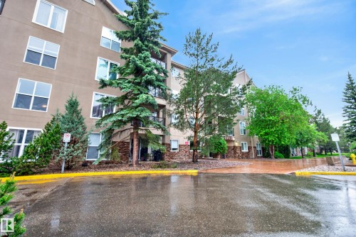 Multi-story building exterior featuring stone detailing on lower levels and multiple windows - 413 8912 156 Street Nw, Edmonton, AB 