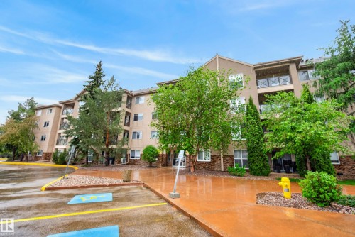 Multi-story residential building featuring a stucco and stone veneer facade - 413 8912 156 Street Nw, Edmonton, AB 