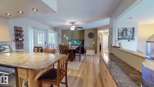 Kitchen island with granite-finish countertop and built-in dishwasher - 4011 Meier Avenue, Drayton Valley, AB 
