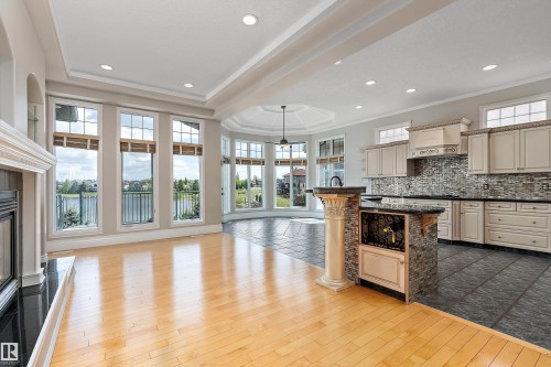 Expansive living space featuring light wood-finish flooring transitioning to large format tile - 16103 89 Street, Edmonton, AB - Indoor Photo Showing Kitchen With Upgraded Kitchen