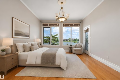 Bright room with wood-finish flooring and an ornate chandelier - 16103 89 Street, Edmonton, AB - Indoor Photo Showing Bedroom