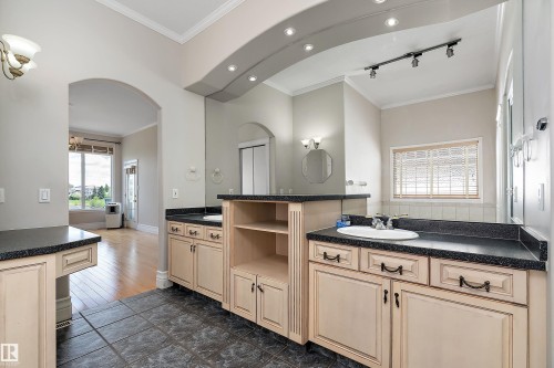 Dual vanity with light cabinetry and dark countertops - 16103 89 Street, Edmonton, AB - Indoor