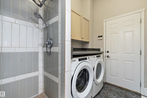 Three-piece shower with a handheld showerhead and a wall-mounted showerhead, featuring gray and white tile - 16103 89 Street, Edmonton, AB - Indoor Photo Showing Laundry Room