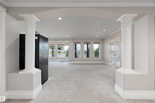 Arched entryway with decorative columns and recessed lighting - 16103 89 Street, Edmonton, AB - Indoor Photo Showing Other Room