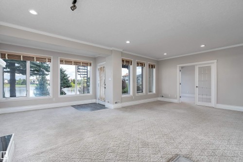 Living area featuring a textured carpet, recessed lighting, and crown molding - 16103 89 Street, Edmonton, AB - Indoor Photo Showing Other Room