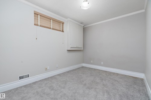 Neutral-toned room featuring a light gray carpet and white crown molding - 16103 89 Street, Edmonton, AB - Indoor Photo Showing Other Room