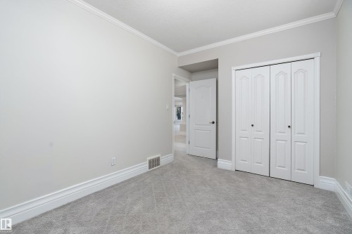 Light gray wall paint complemented by white crown molding and baseboards - 16103 89 Street, Edmonton, AB - Indoor