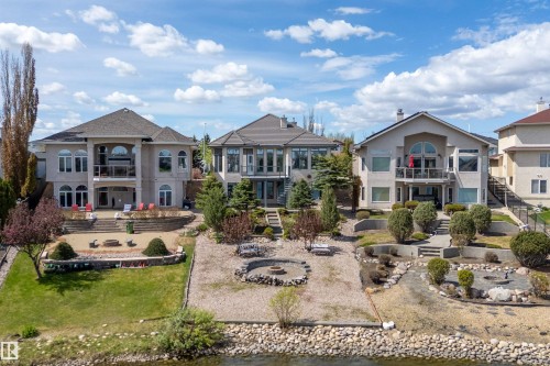 Rear elevation featuring multiple balconies, terraced landscaping, a lower patio, and a water feature - 16103 89 Street, Edmonton, AB - Outdoor With Facade