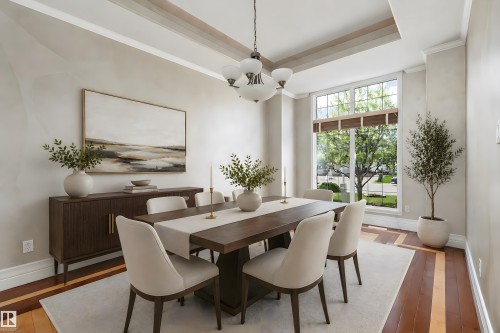 Dining area featuring a coffered ceiling, a large picture window, and wood-finish flooring with a light-toned inlay - 16103 89 Street, Edmonton, AB - Indoor Photo Showing Dining Room