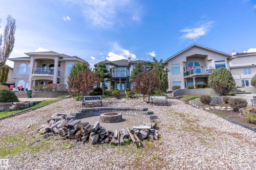 Expansive terraced yard with a stone paver fire pit area - 16103 89 Street, Edmonton, AB - Outdoor With Facade