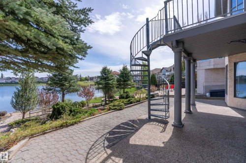 Exterior balcony featuring a spiral staircase and supporting columns - 16103 89 Street, Edmonton, AB - Outdoor With Body Of Water