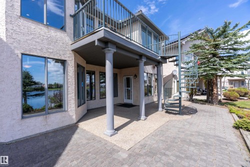 Exterior patio featuring a covered seating area, a spiral staircase, and a second-story balcony - 16103 89 Street, Edmonton, AB - Outdoor