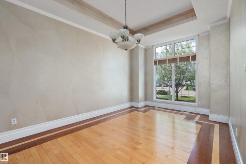 Hardwood flooring with a decorative inlaid border - 16103 89 Street, Edmonton, AB - Indoor Photo Showing Other Room