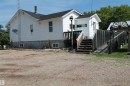 White siding exterior with a dark shingle roof. - 125 56524 Rng Rd 52A, Lindbergh, AB 