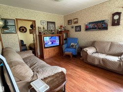 Wood-finish flooring complements patterned wallpaper. - 