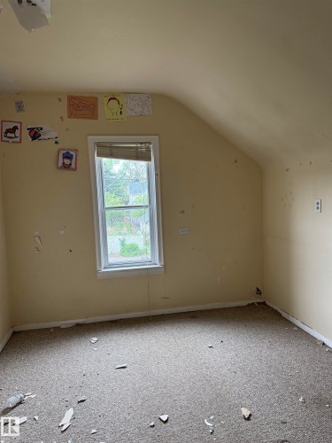 Windowed room with an angled ceiling. - 9740 87 Avenue, Edmonton, AB 