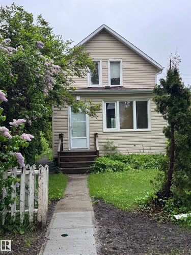 Two-story residence featuring light-colored horizontal siding and white trim - 9740 87 Avenue, Edmonton, AB 