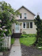 Two-story residence featuring light-colored horizontal siding and white trim - 