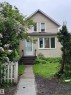 Two-story residence featuring light-colored horizontal siding and white trim - 9740 87 Avenue, Edmonton, AB 