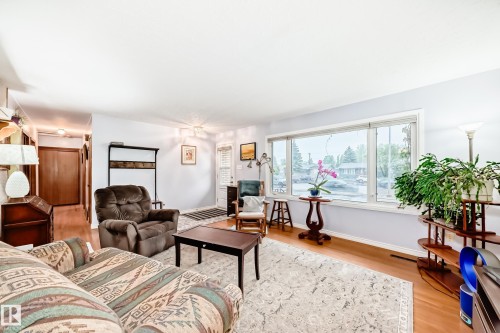 Living area with light-toned walls and wood-finish flooring - 8006 159 Street, Edmonton, AB 