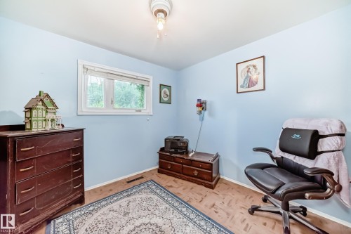 Light blue walls define this space, featuring a window with white trim - 8006 159 Street, Edmonton, AB 