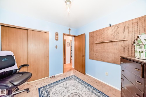 Room featuring light blue walls and wood-finish flooring - 8006 159 Street, Edmonton, AB 