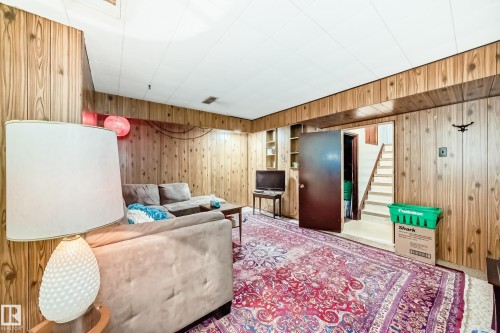 Finished room featuring wood paneling, drop ceiling, and carpeted flooring - 8006 159 Street, Edmonton, AB 
