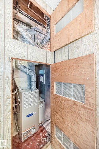 Utility closet featuring a Carrier brand furnace and hot water heater - 8006 159 Street, Edmonton, AB 