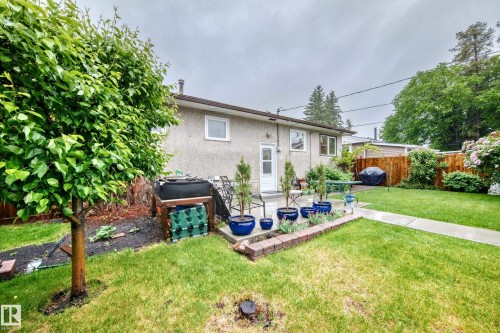 Rear exterior of a residence featuring a stucco finish and white-framed windows - 8006 159 Street, Edmonton, AB 