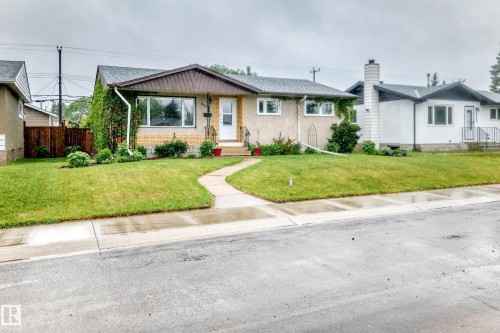 Single-story residence featuring a gabled roof and a front lawn - 8006 159 Street, Edmonton, AB 