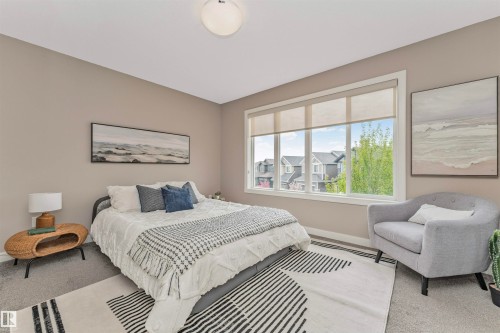 Spacious room featuring neutral-toned walls, a large window with roller shades, and plush carpeting - 22124 85 Avenue, Edmonton, AB - Indoor Photo Showing Bedroom