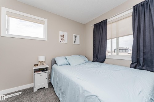 Bedroom featuring neutral wall paint, white trim, and gray carpet flooring - 22124 85 Avenue, Edmonton, AB - Indoor Photo Showing Bedroom