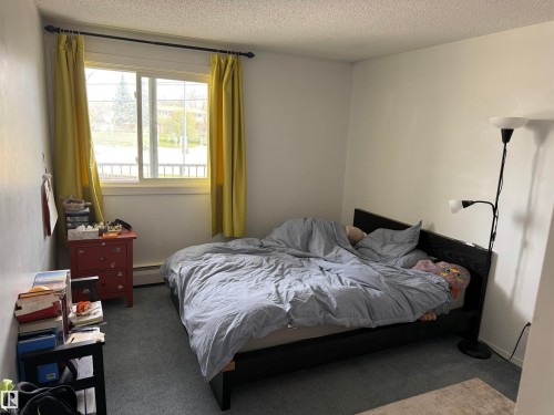 Bright interior space with light-colored walls and soft textured carpeting - 225 4404 122 Street, Edmonton, AB 
