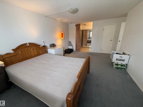 Spacious room featuring neutral carpeting and white walls - 225 4404 122 Street, Edmonton, AB 