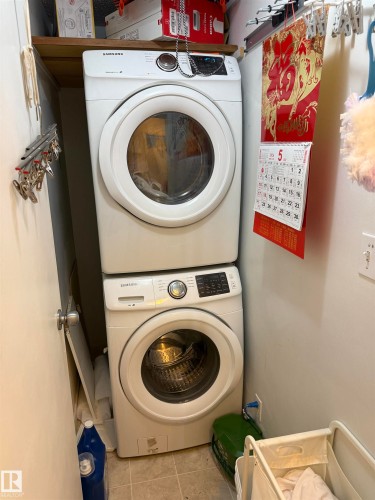 Dedicated laundry area featuring a stacked washer and dryer - 225 4404 122 Street, Edmonton, AB 