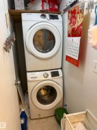 Dedicated laundry area featuring a stacked washer and dryer - 