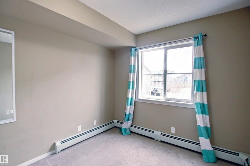 Neutral-toned walls complement light gray carpeting - 215 1510 Watt Drive, Edmonton, AB 